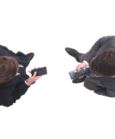 top view . two businessmen looking at the screens of their smartphonesの写真素材