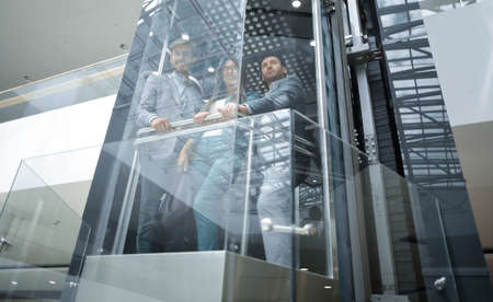 Business team group going on elevator.の写真素材