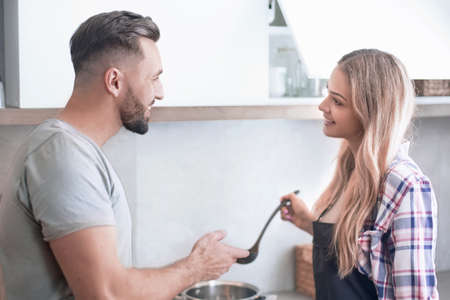 young man is preparing dinner for his familyの写真素材