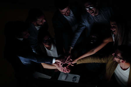 close up.young colleagues joined together their handsの写真素材