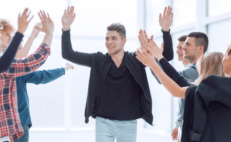 rear view. leader and business team applauding their successの写真素材