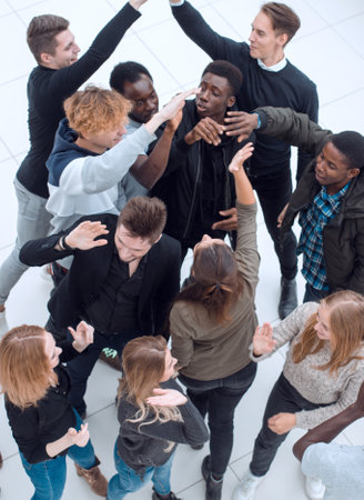 top view. happy young people giving each other a high five .の写真素材