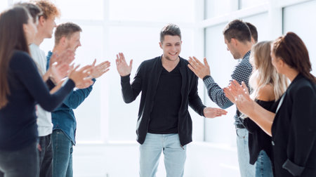 smiling leader accepting the congratulations of his business team