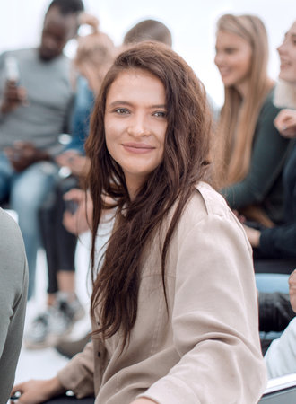 young woman sitting in a circle of diverse young people