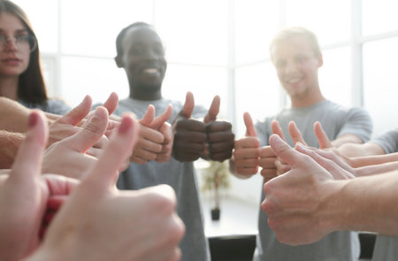 close up. group of young people showing thumbs up.