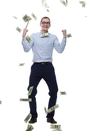 happy man standing in the rain of banknotes. isolated on a whiteの写真素材
