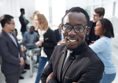 close up. smiling young businessman standing in the office.の写真素材