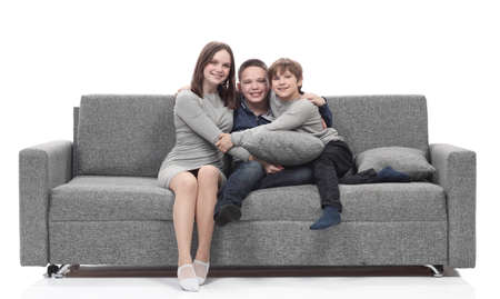 happy family sitting on a large comfortable sofa.の写真素材