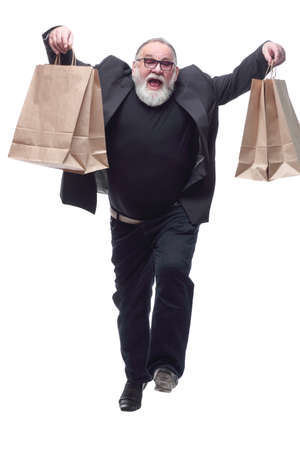 smiling business man with shopping bags striding forward .の写真素材
