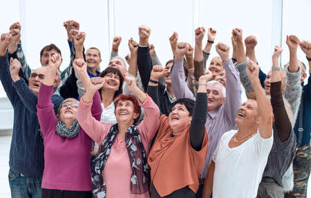 a group of elderly people raised their hands upの写真素材