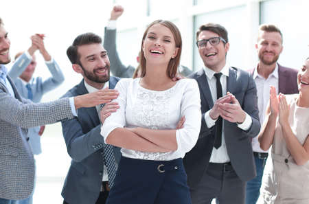 confident team leader standing in front of her colleagues
