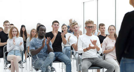 casual group of young people meditating sitting on the floor.の写真素材