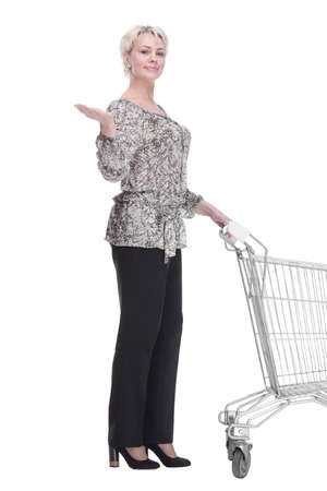 elegant young woman with a shopping cart looking at you .の写真素材