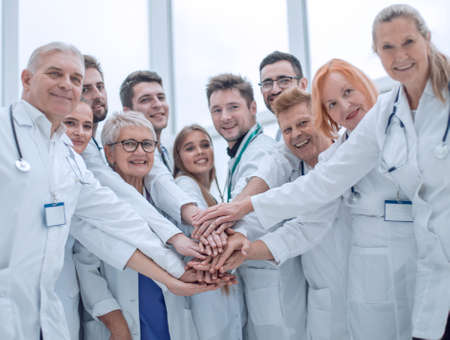 large group of doctors put their hands together.の写真素材