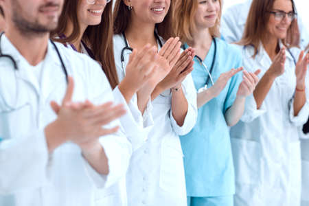 group of diverse doctors applauding their joint successの写真素材