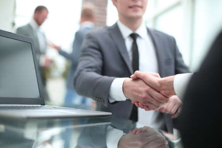 close up. smiling Manager shaking hands with the client