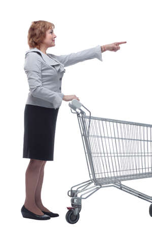 Side view of happy woman pushing an empty shopping cartの写真素材