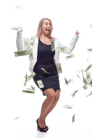 very happy business woman standing in a rain of dollar bills.の写真素材
