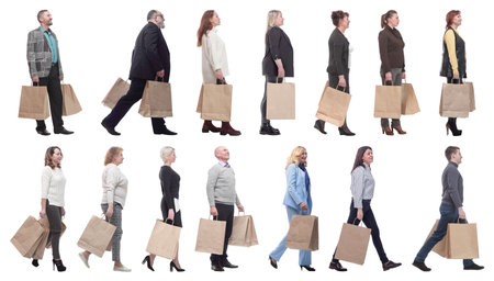 a group of people are running paper shopping bagsの写真素材