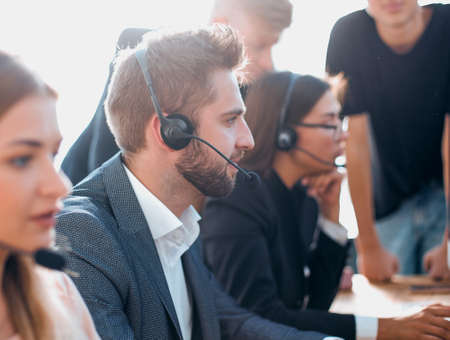 working group in the headset is working in the officeの写真素材