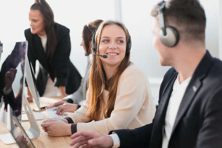 employees of the analytical service sitting at a Desk.