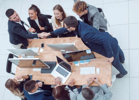 top view. business colleagues shaking hands at an office meeting.