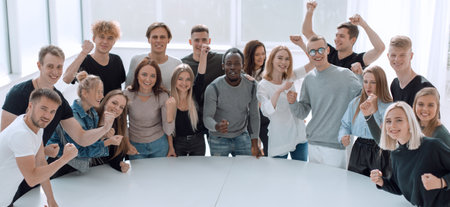 diverse young people standing near a round tableの写真素材
