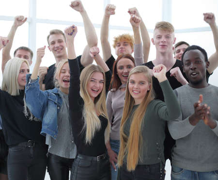 close up. group of smiling young people showing their success
