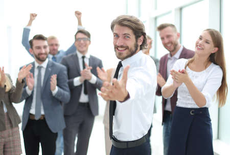 happy young business man pointing at you.の写真素材