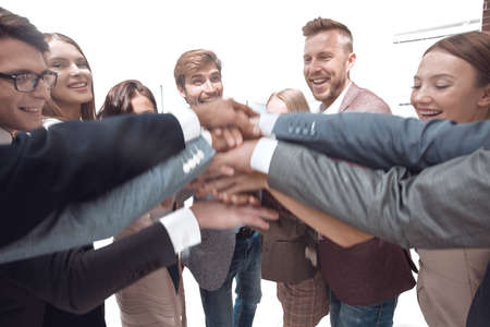 close up. a group of successful young people putting their hands togetherの写真素材