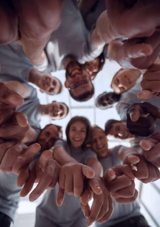 bottom view. a group of successful young people pointing at you
