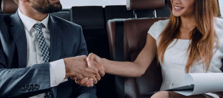 Businessman was congratulated in the car for completing the jobの写真素材