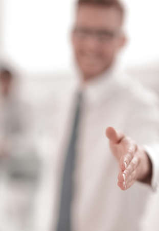 blurred image. business man holding out his hand for a handshakeの写真素材