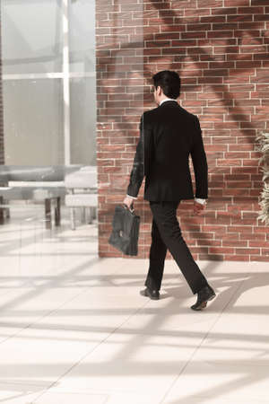 businessman walks in his officeの写真素材