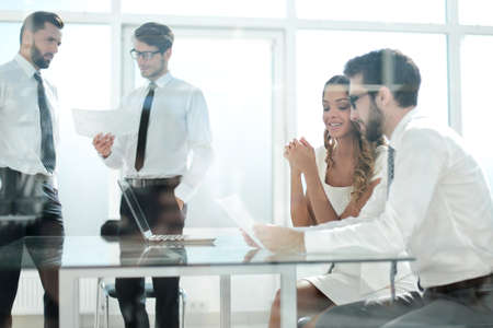 through the glass .business team in the officeの写真素材