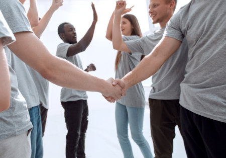 jubilant team of young people congratulating each other on the v