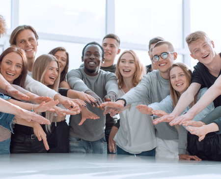 multinational group of young people joining their palms