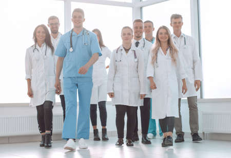group of confident doctors striding in the hospital corridorの写真素材
