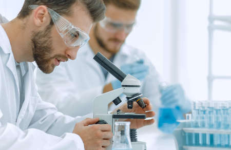 biologist explores the substance under the microscope