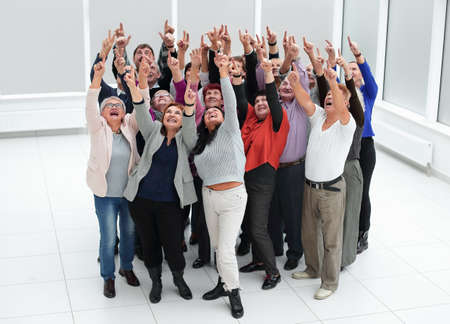a group of older people raised their hands trying to reachの写真素材