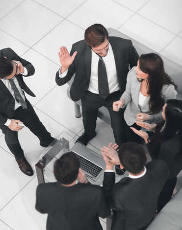 Happy successful business team giving a high fives gesture as th
