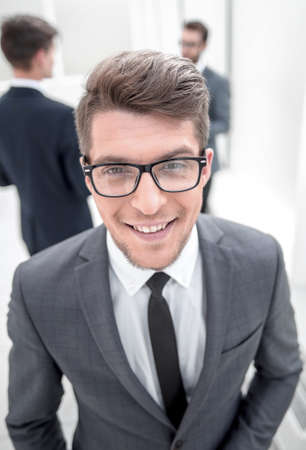 close up.confident young businessman on blurred office backgroundの写真素材