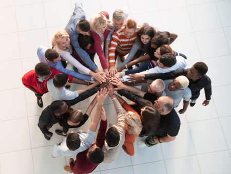 Group of people with hands together - teamwork concepts