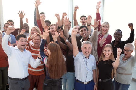 Business team raising their hands up to celebrate victory
