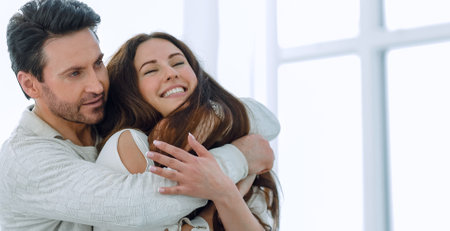 portrait of a couple in love sitting near the window.の写真素材