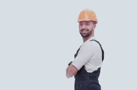 in full growth. smiling man in overalls and a safety helmet