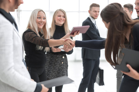 young business colleagues confidently shaking hands.business conceptの写真素材