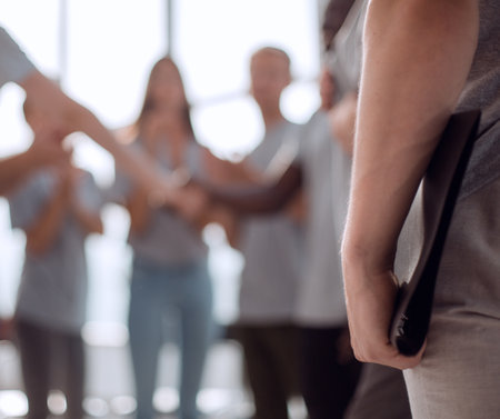Contact group of young people applauding their coachの写真素材
