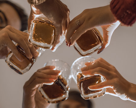 background image of a glass of juice in the hands of the young coupleの写真素材