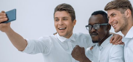 three young employees take selfiesの写真素材